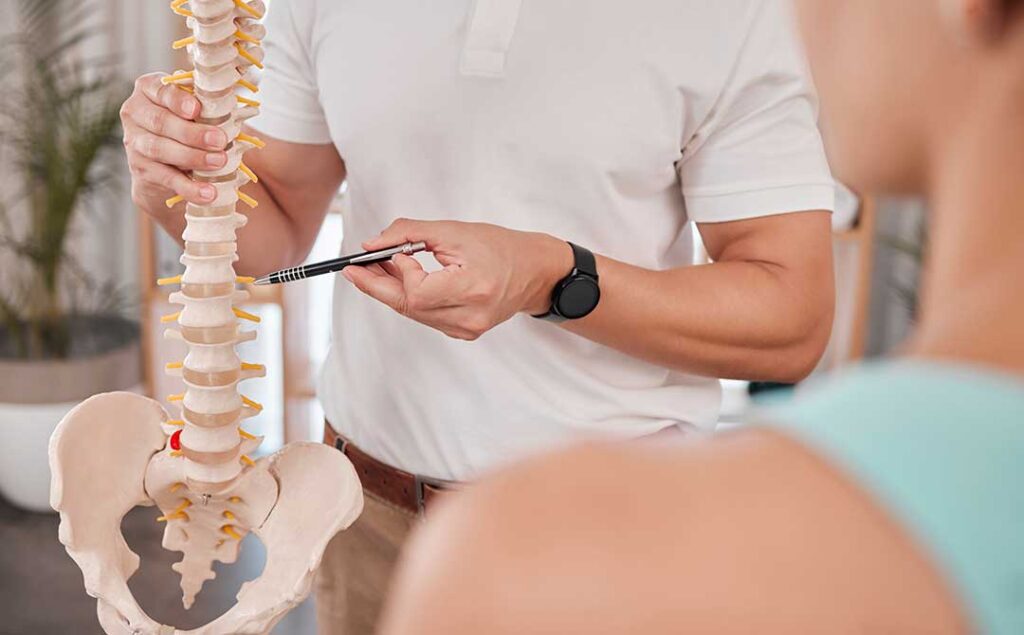 A chiropractor gently performing a spinal adjustment on a patient in a well-lit clinic setting.