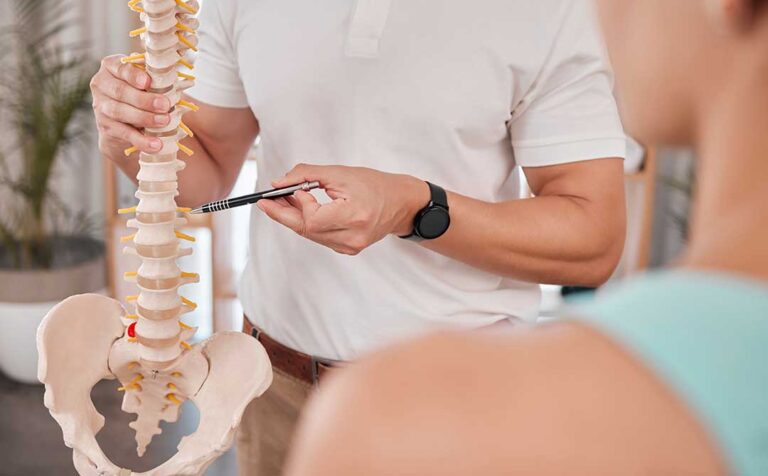 A chiropractor gently performing a spinal adjustment on a patient in a well-lit clinic setting.